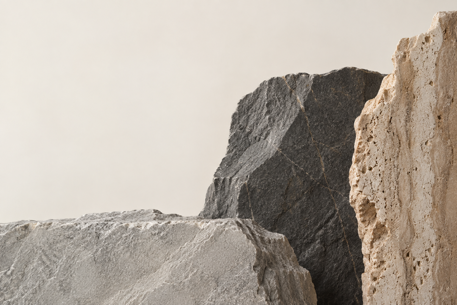 Sculptural stone surfaces in warm ivory, grey and charcoal